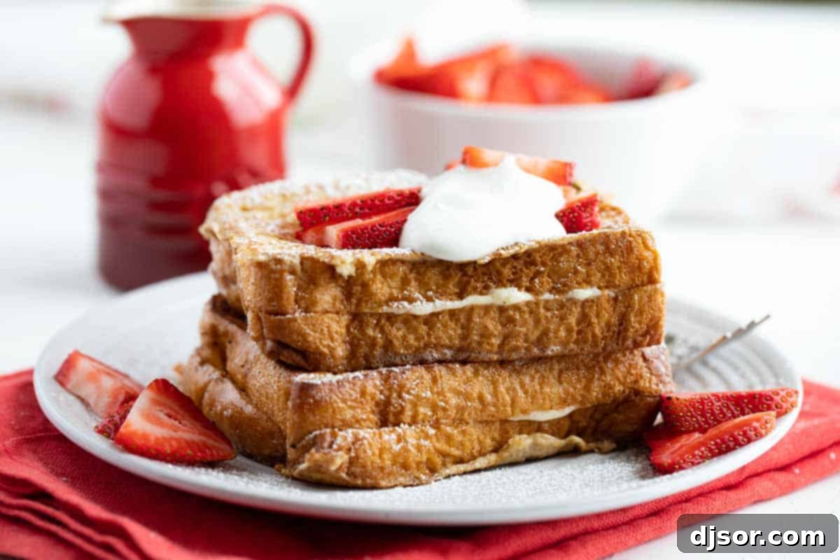 Plate with two servings of Stuffed French Toast with strawberries and whipped cream