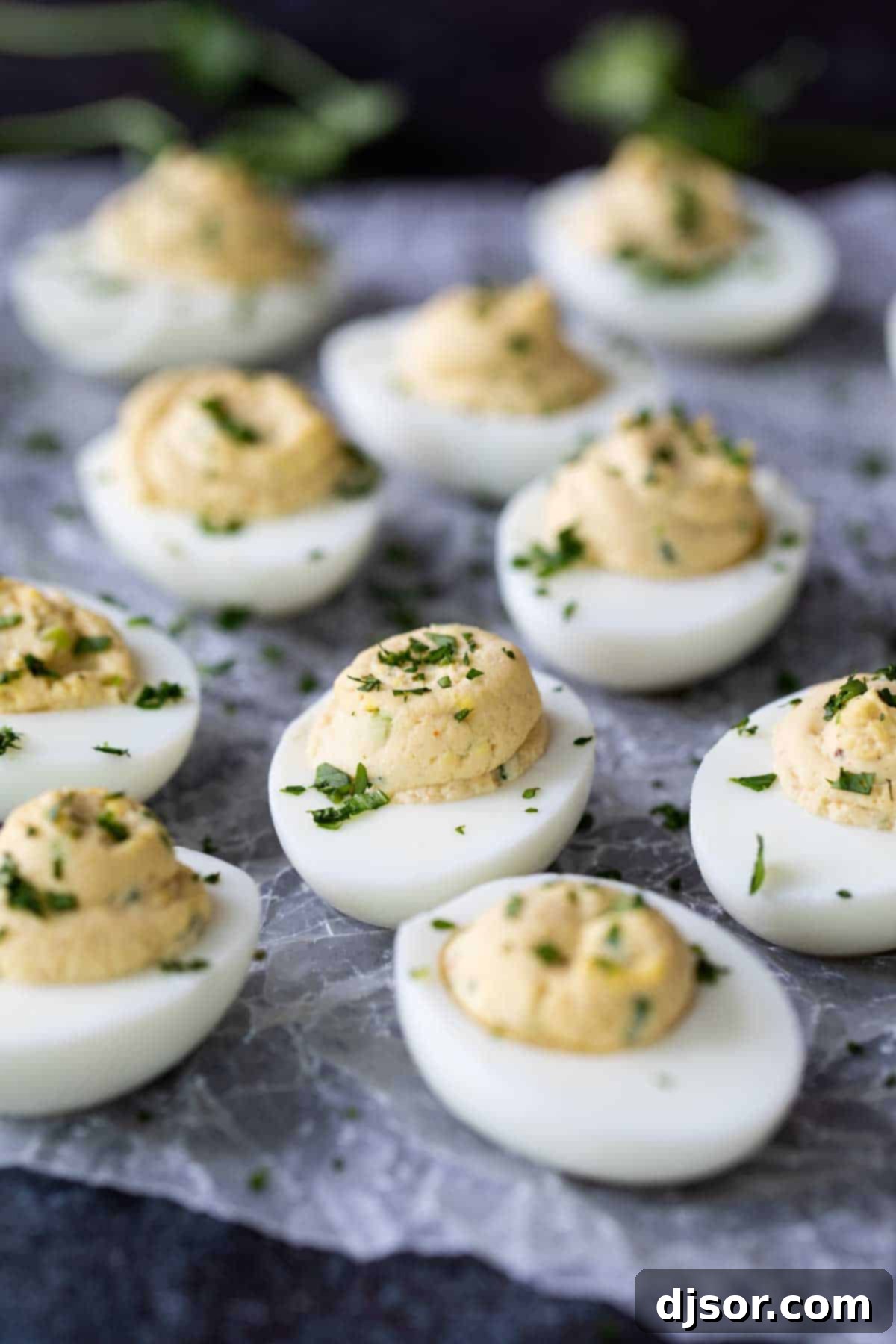 A vibrant plate of Asian-inspired deviled eggs, possibly garnished with sesame seeds or sriracha drizzle.