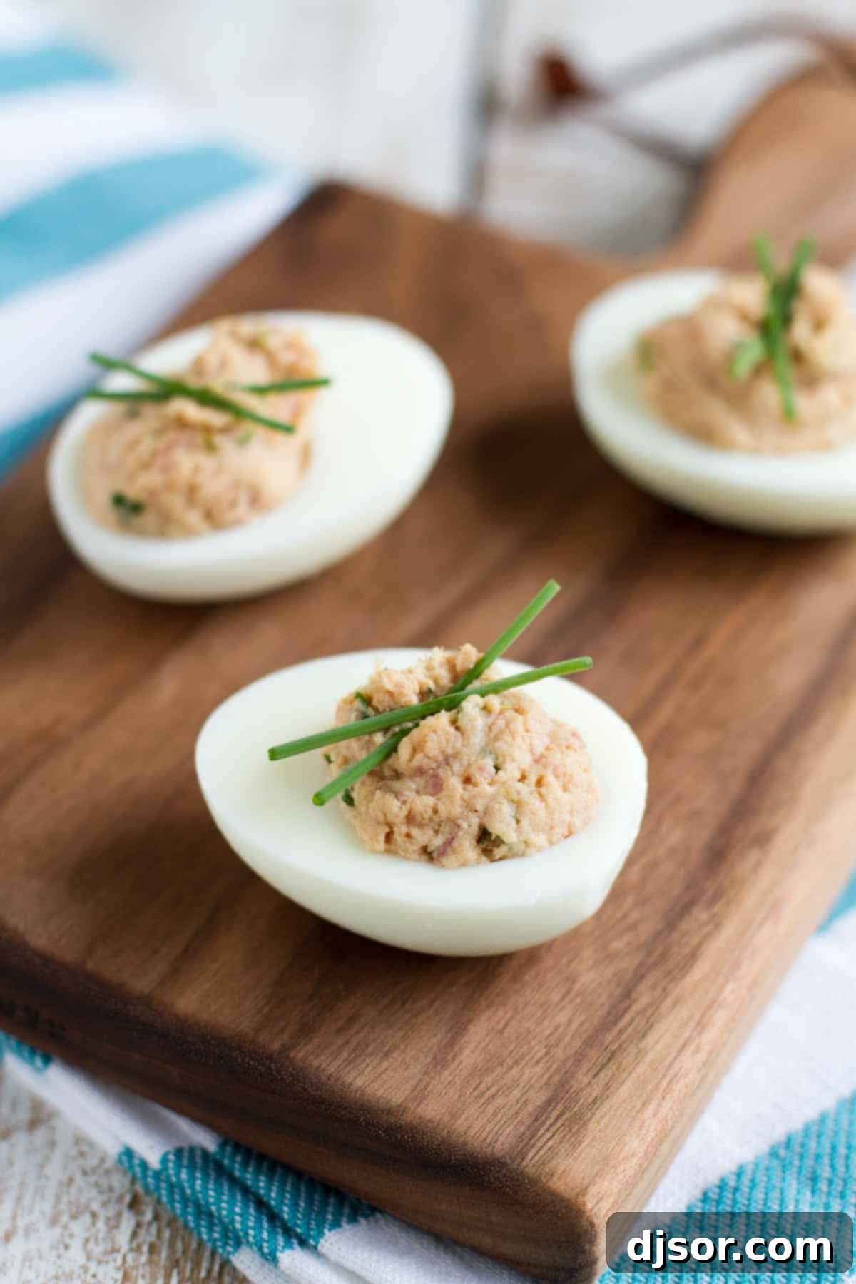 Deviled eggs with a hearty ham filling, garnished with fresh parsley.