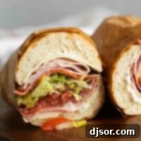 The Ultimate Italian Stack 9 Italian Sub cut in half with the meat, cheese, and vegetables showing, ready for serving.