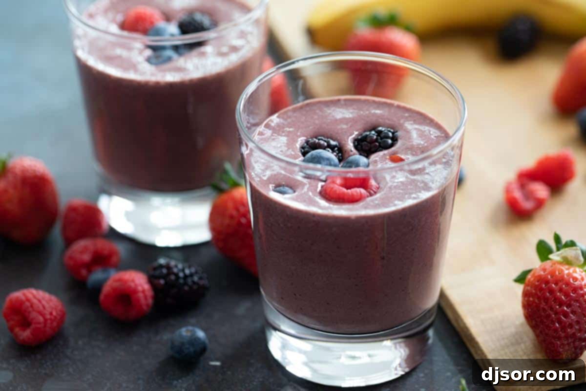 A delicious Chocolate Berry Smoothie topped with fresh mixed berries, ready to be enjoyed.
