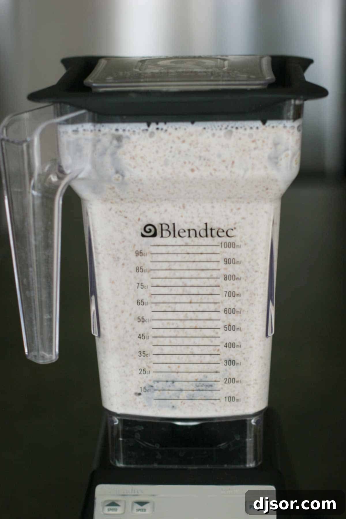 Whole Wheat Blender Pancakes - Use your blender to turn raw whole wheat into pancakes – the perfect breakfast! A high-angle shot of creamy, thick pancake batter swirling inside a blender pitcher, ready to be poured onto the griddle.