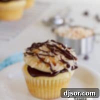 Samoa Cupcakes: A yellow cupcake filled with caramel and topped with chocolate ganache, caramel buttercream, and toasted coconut.