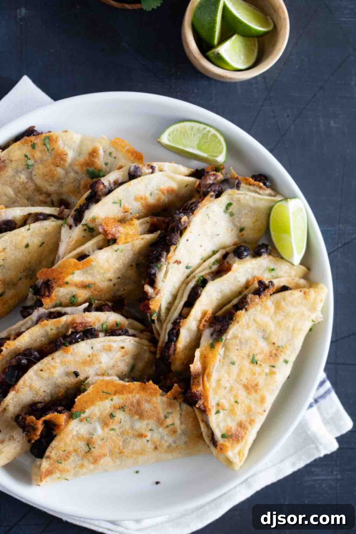 black bean tacos on a plate with lime wedges