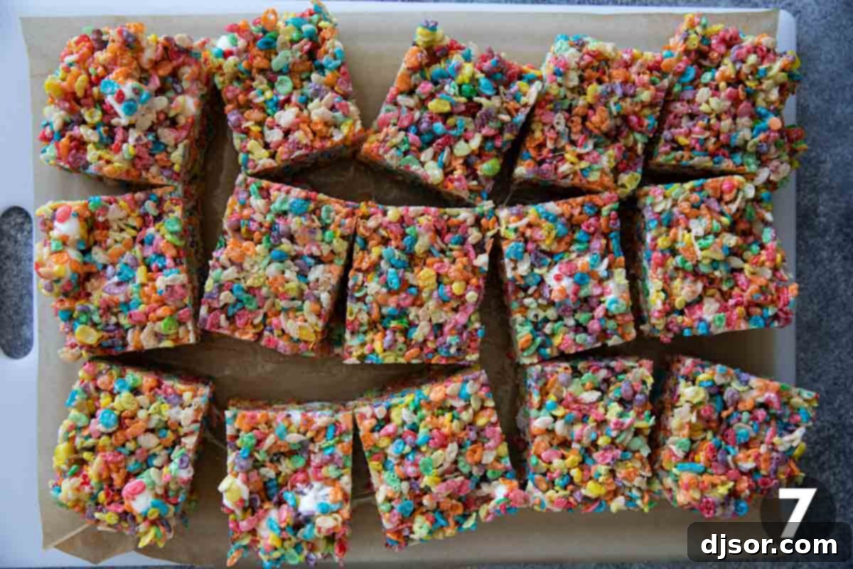Fruity Pebble Rice Crispy Treats, freshly cut into squares, showcasing their colorful appearance and soft texture.
