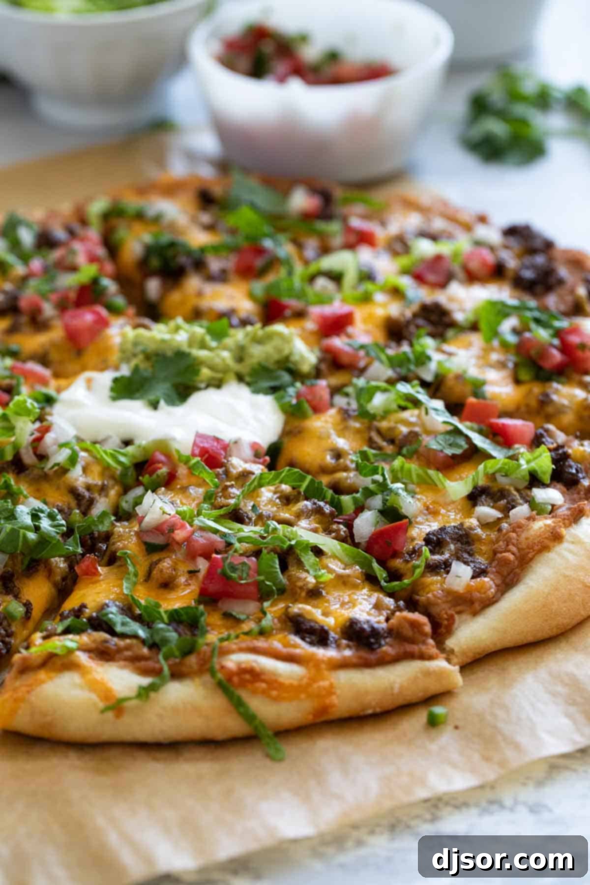 Pizza topped with taco meat, beans, and cheese.