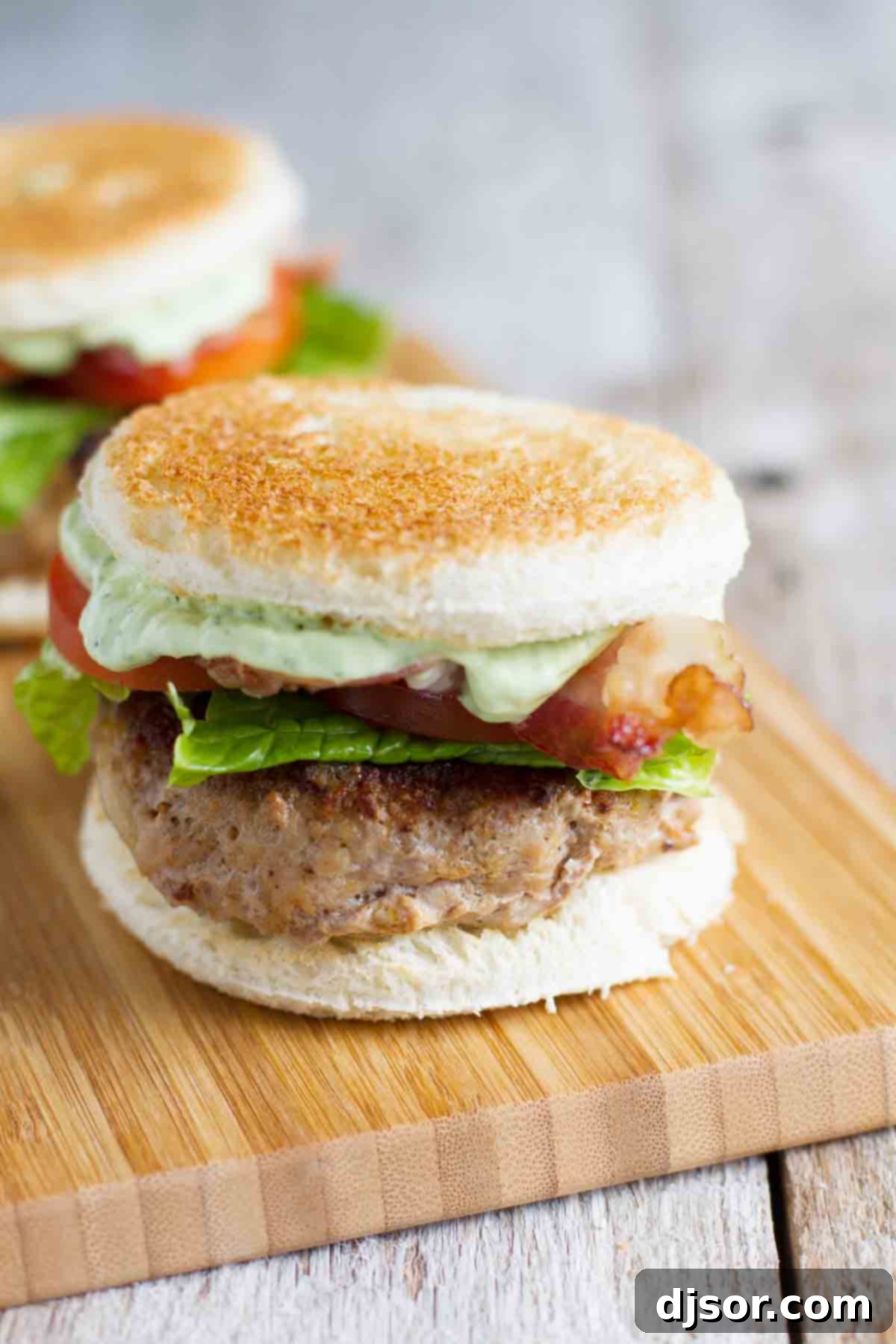 Close-up of perfectly grilled Club Burger Sliders with toasted buns and fresh toppings