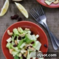 A beautifully plated Winter Salad showcasing fresh ingredients and a generous serving of homemade Lemon Poppy Seed Dressing.