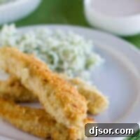 Tortilla Crusted Chicken Tenders on a plate with dipping sauce in the background.