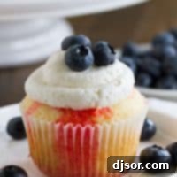 Jiggly Jell-O Poke Cupcakes 6 A beautifully decorated Jello poke cupcake with red, white, and blue elements, highlighting its patriotic appeal.