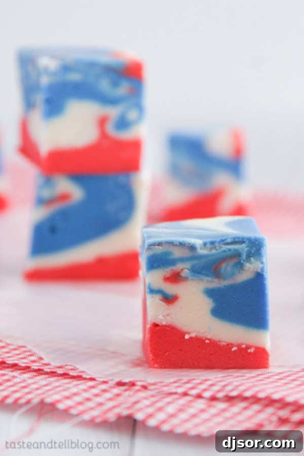 Jiggly Jell-O Poke Cupcakes 7 A slice of festive red, white, and blue tie-dyed fudge, a sweet treat for Fourth of July.