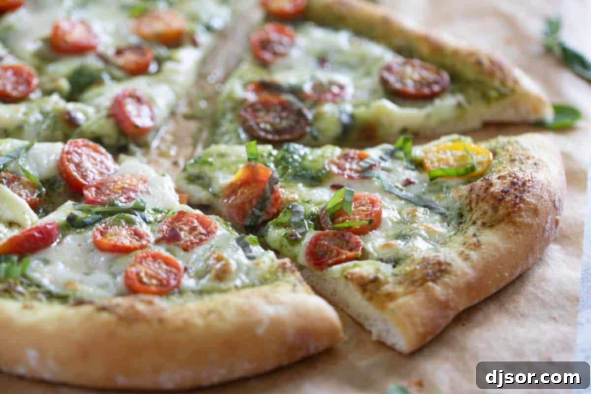 A close-up of a freshly baked Pesto Pizza, sliced into inviting wedges, adorned with juicy cherry tomatoes, golden-brown melted mozzarella, and fragrant fresh basil leaves, resting on a rustic wooden pizza board, ready to be enjoyed.