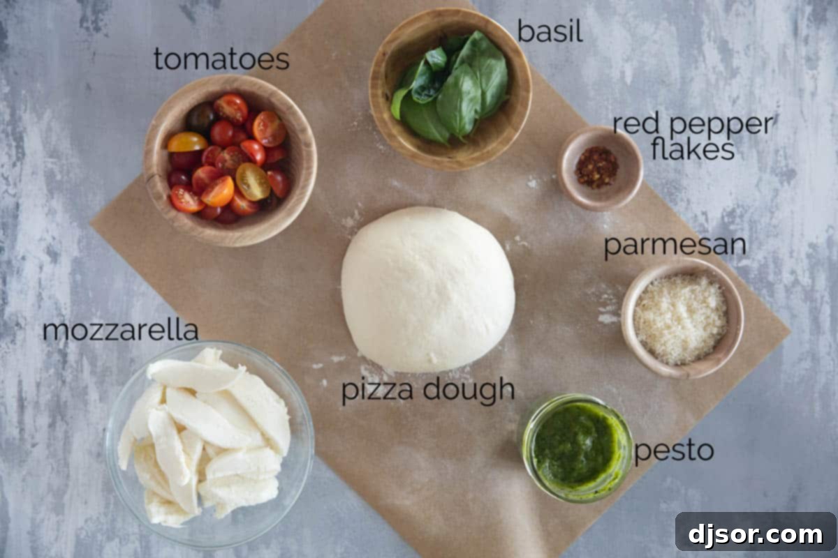 An overhead shot showcasing the fresh, vibrant ingredients required for an authentic Pesto Pizza, meticulously arranged on a rustic wooden board: a round of homemade pizza dough, a bowl brimming with bright green basil pesto, halved cherry tomatoes, and a block of fresh mozzarella cheese.