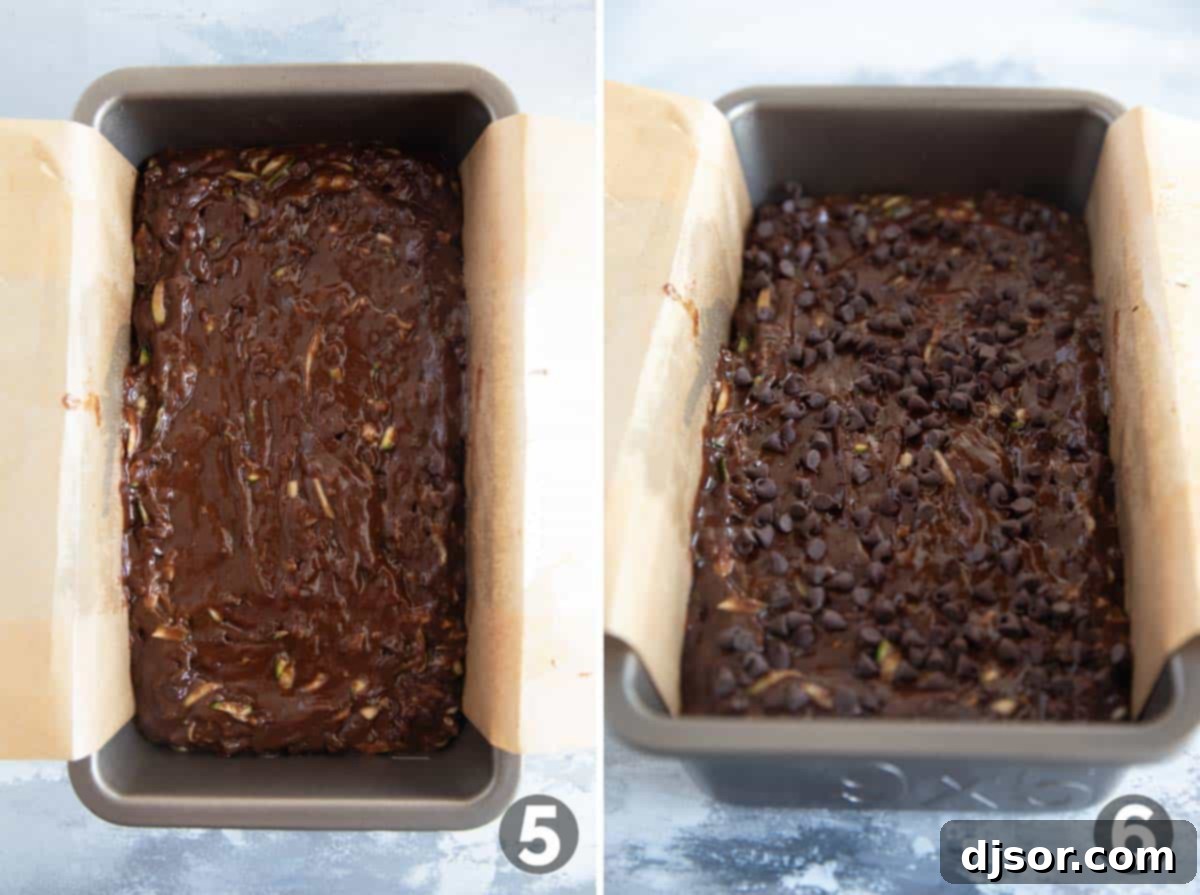 Chocolate zucchini bread batter poured into a parchment-lined loaf pan, topped with extra chocolate chips.