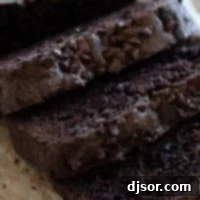 Slices of chocolate zucchini bread topped with mini chocolate chips.