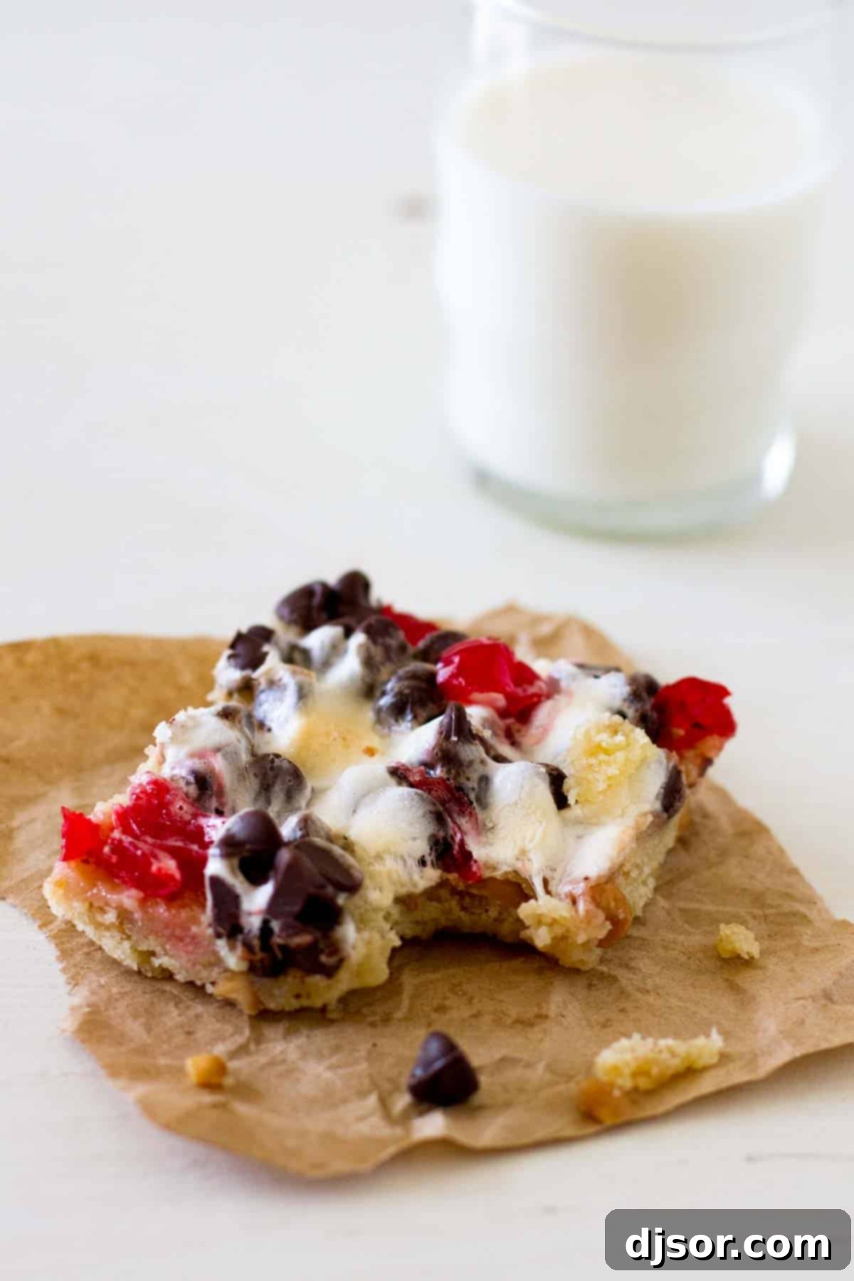 Tropical Sundae Bars 3 A single banana split bar with a bite taken out, revealing gooey marshmallows and chocolate