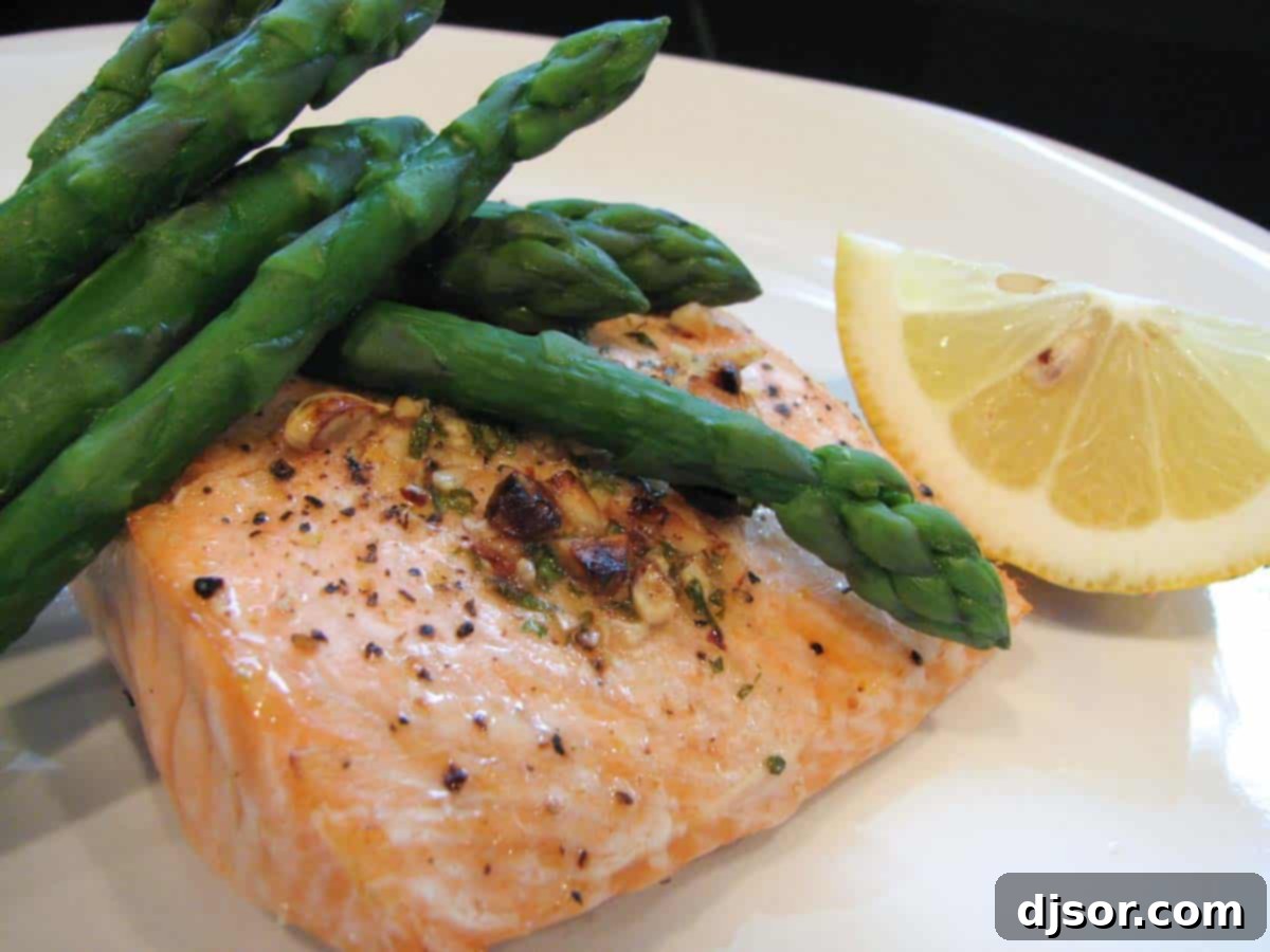 Gourmet Grilled Salmon with Hazelnut Butter Recipe Perfectly grilled salmon fillets topped with a generous dollop of hazelnut butter, served alongside fresh green asparagus.