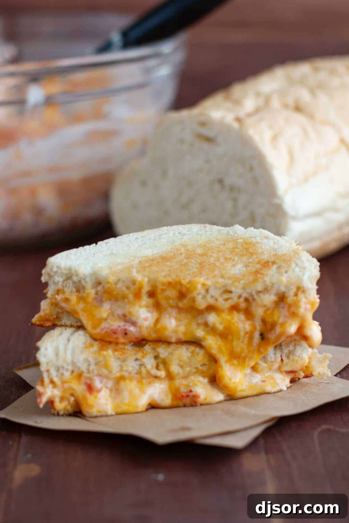 Two halves of Pimento Grilled Cheese sandwiches stacked on top of each other, ready to serve.