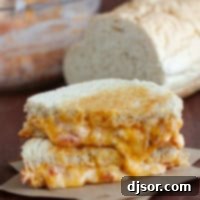 Close-up of a Pimento Grilled Cheese sandwich, cut in half and stacked.