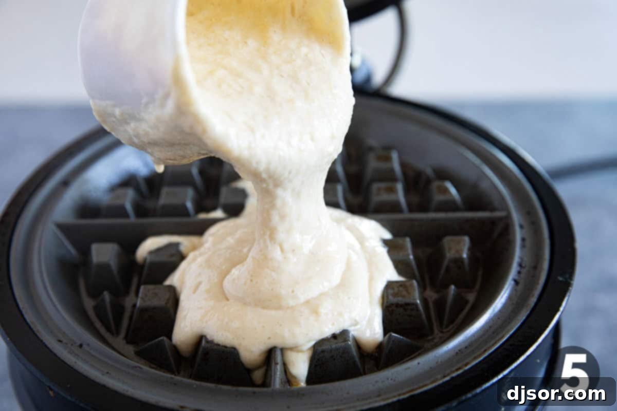 Classic Belgian Waffles 6 Pouring batter onto a waffle iron.