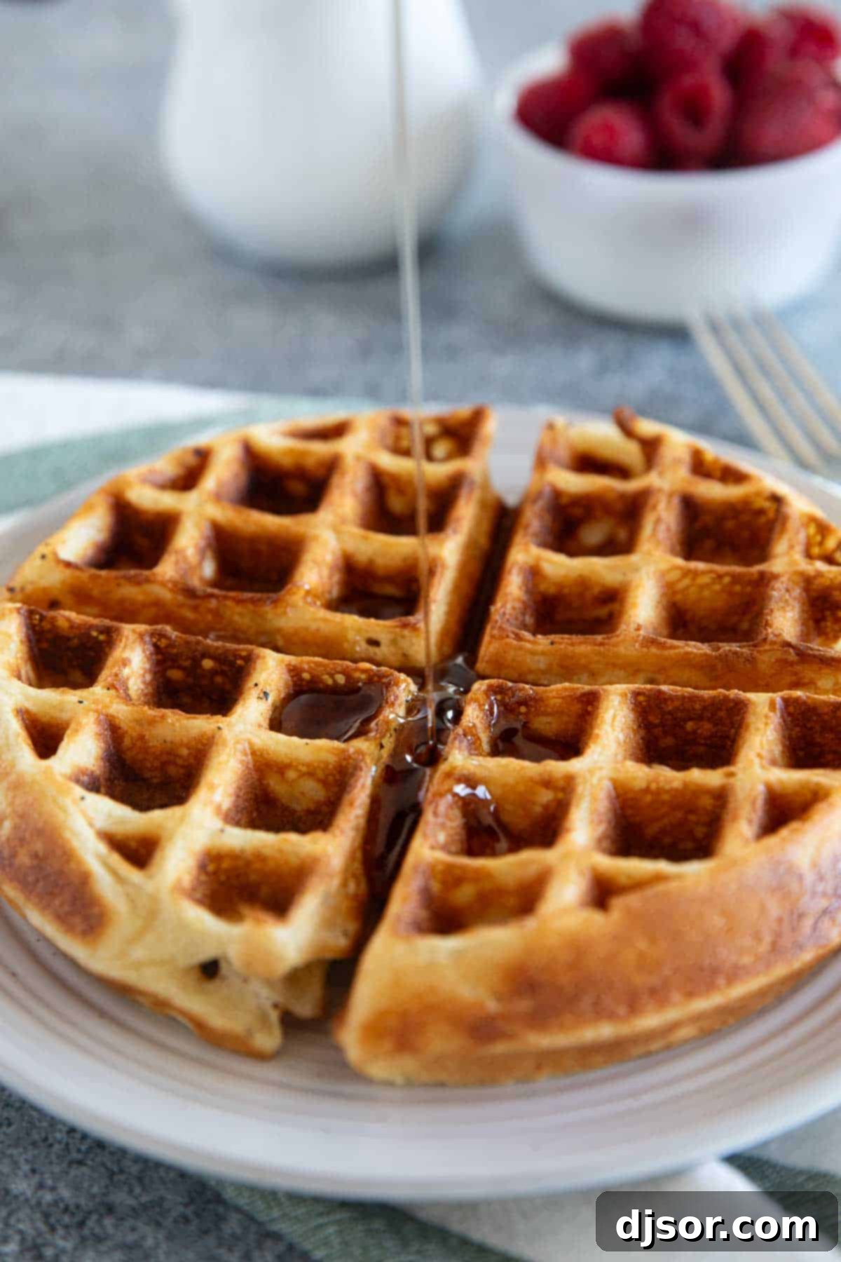 Classic Belgian Waffles 7 Pouring syrup onto a Belgian waffle.