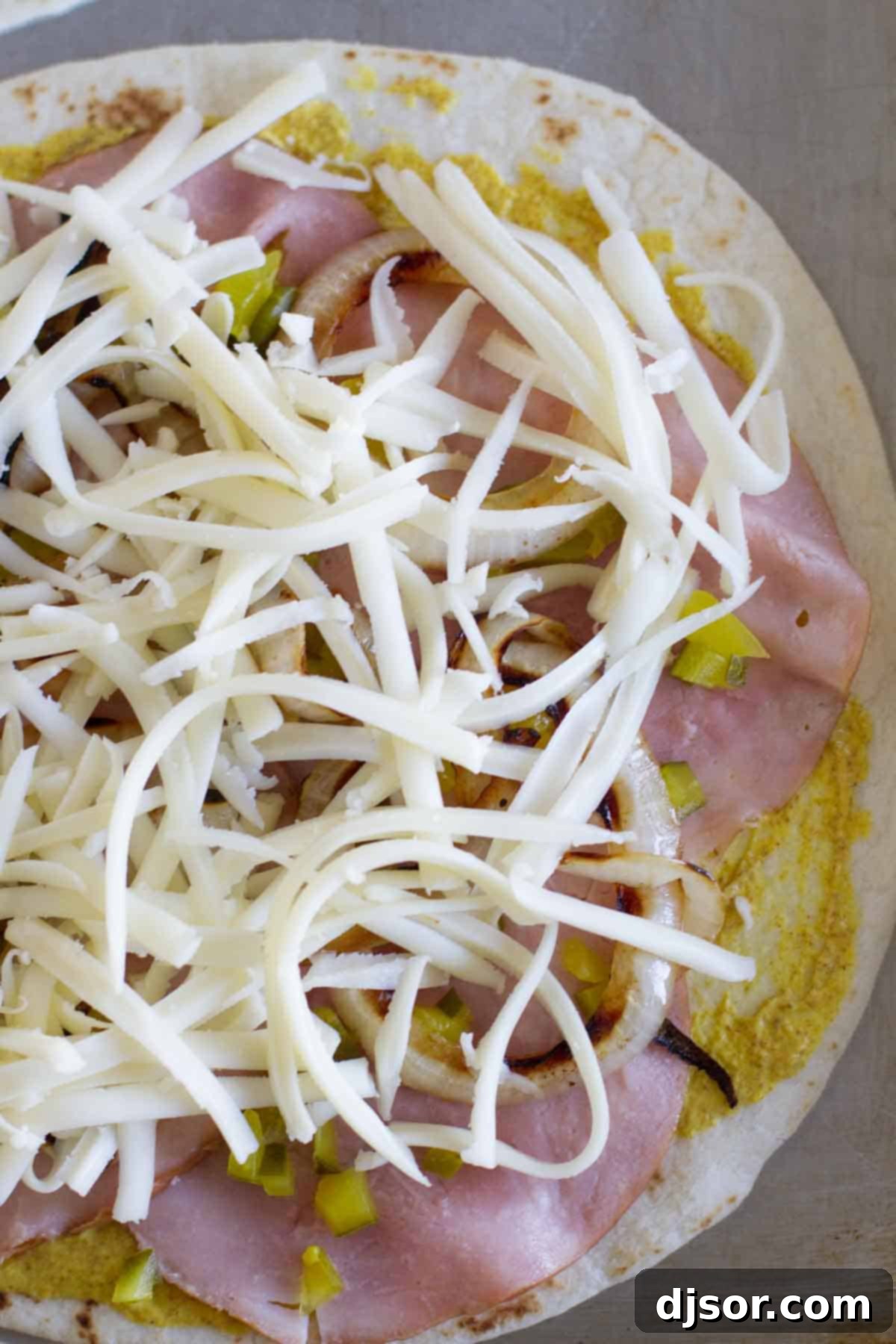 Easy Cuban Quesadilla Delight 3 Ingredients for a Cuban quesadilla meticulously stacked on a flour tortilla before folding.