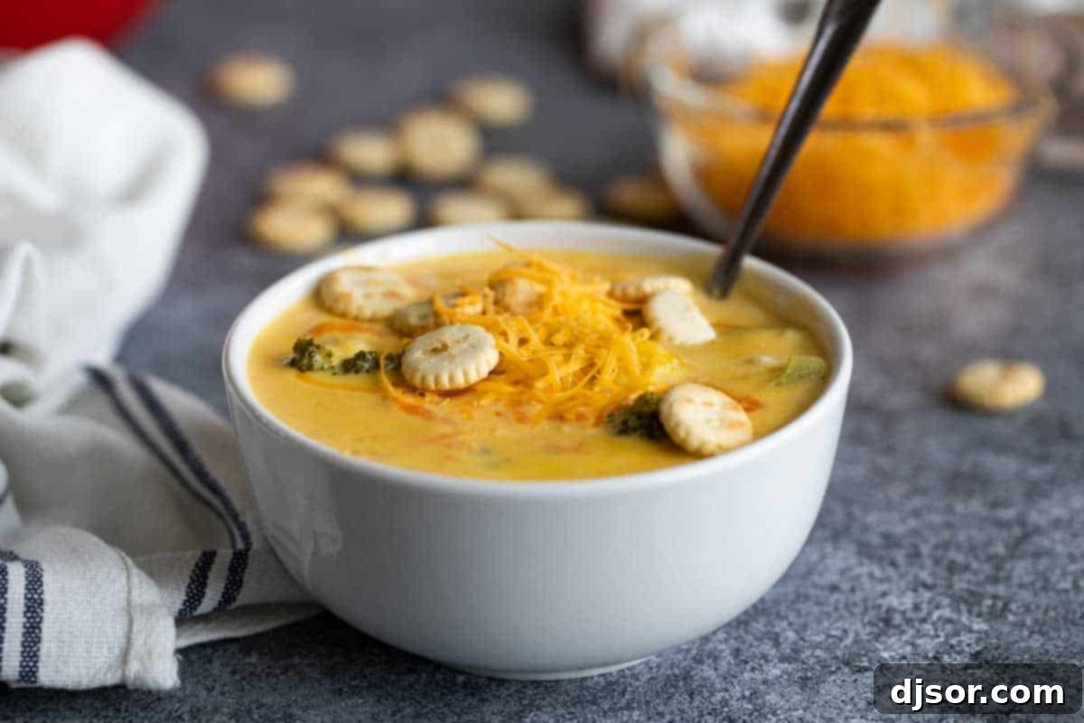 bowl of Broccoli Cheddar Soup topped with cheese and crackers