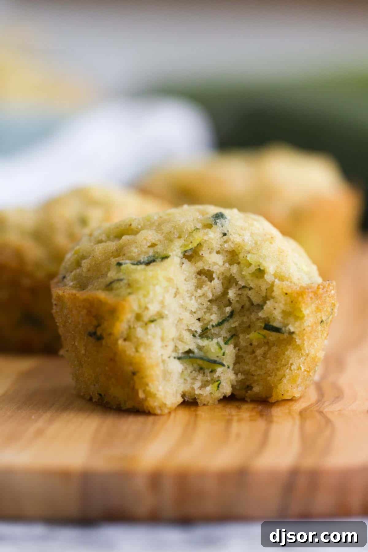 close up of zucchini muffin with a bite taken from it