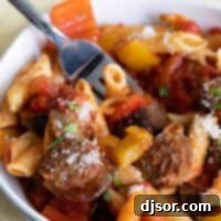 Robust Sausage and Peppers Pasta 2 bowl of sausage and peppers pasta with a fork
