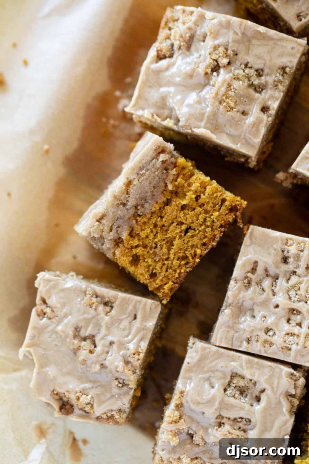 Pumpkin Coffee Cake with a slice turned on its side, revealing the layers of cake, streusel, and glaze.