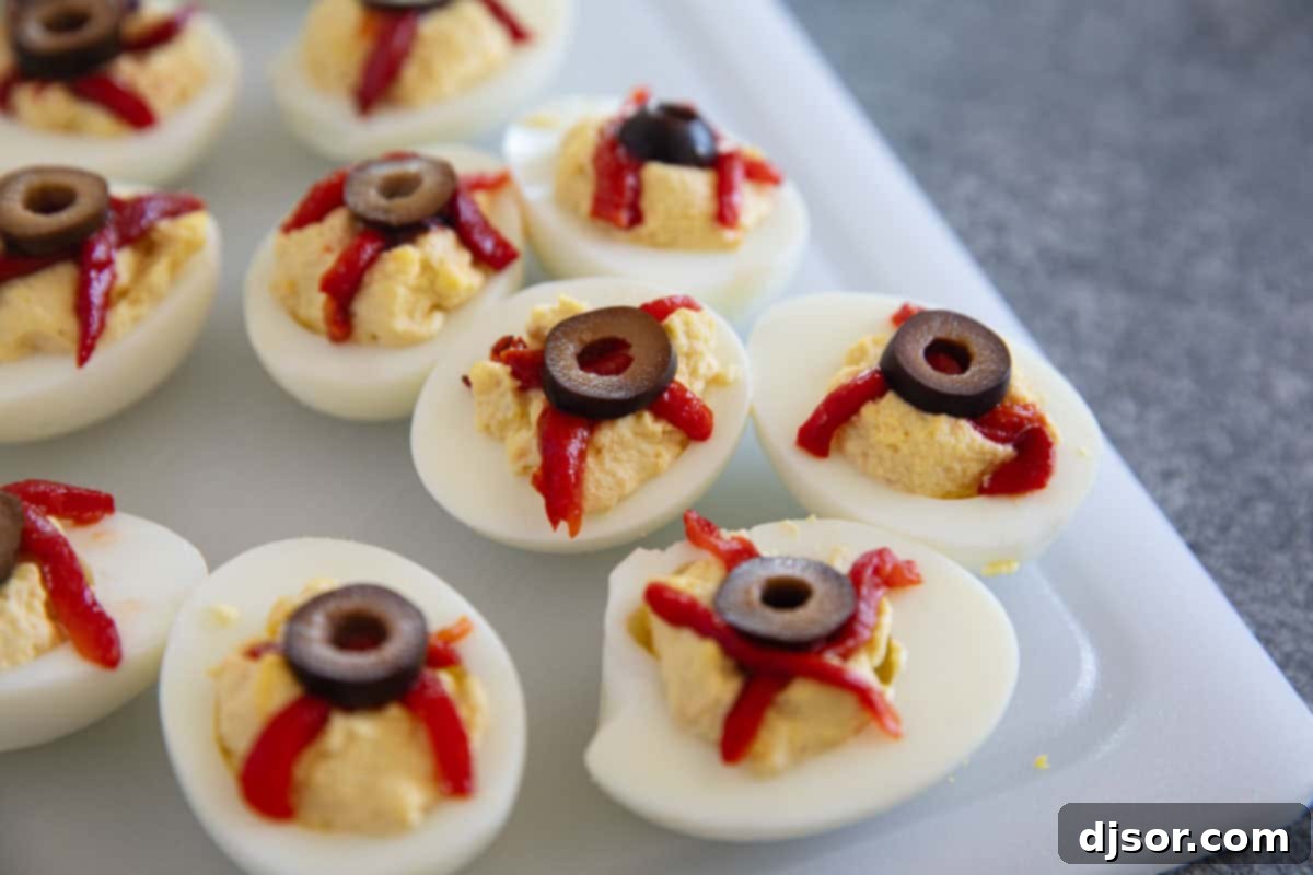 Ghastly Deviled Eggs 8 Deviled eggs decorated as bloodshot eyeballs with roasted red peppers and black olives.