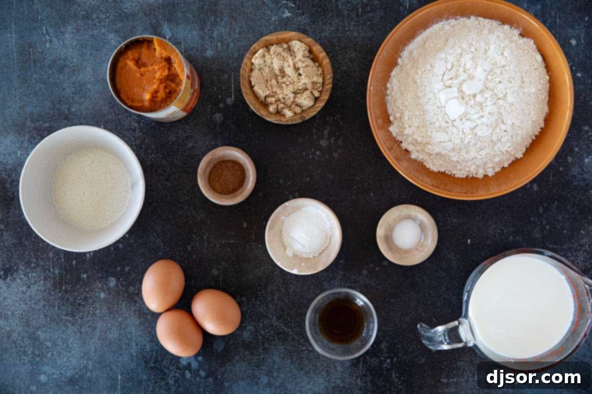 Autumn Pumpkin Waffles 3 A beautiful flat lay of all the fresh ingredients required to make delicious Pumpkin Waffles, including flour, brown sugar, eggs, milk, canned pumpkin puree, and a selection of warming spices.