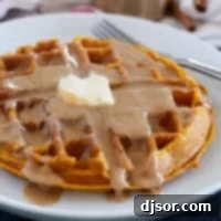 Autumn Pumpkin Waffles 9 Pumpkin Waffles on a white plate topped with cinnamon syrup.