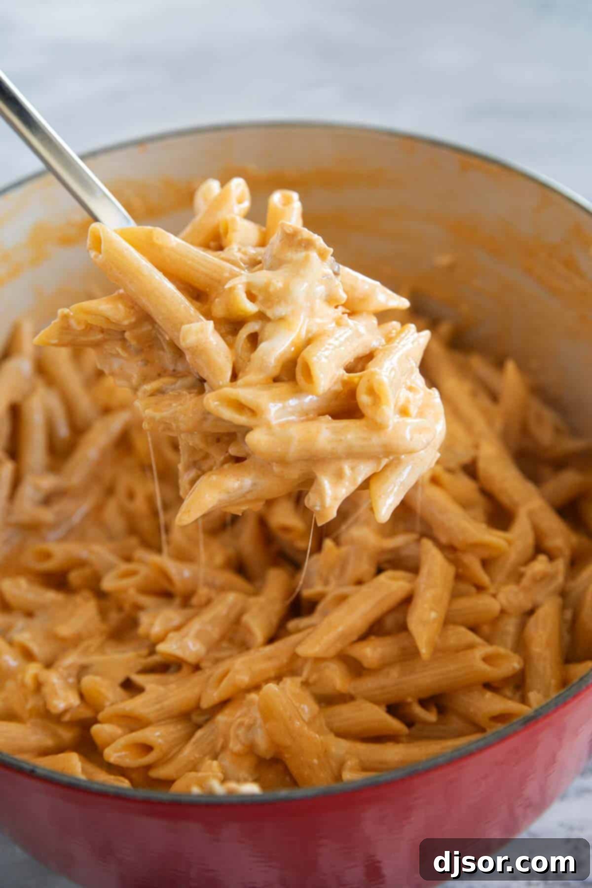 Ultimate Buffalo Chicken Pasta 7 Large spoon with a scoop of buffalo chicken pasta.