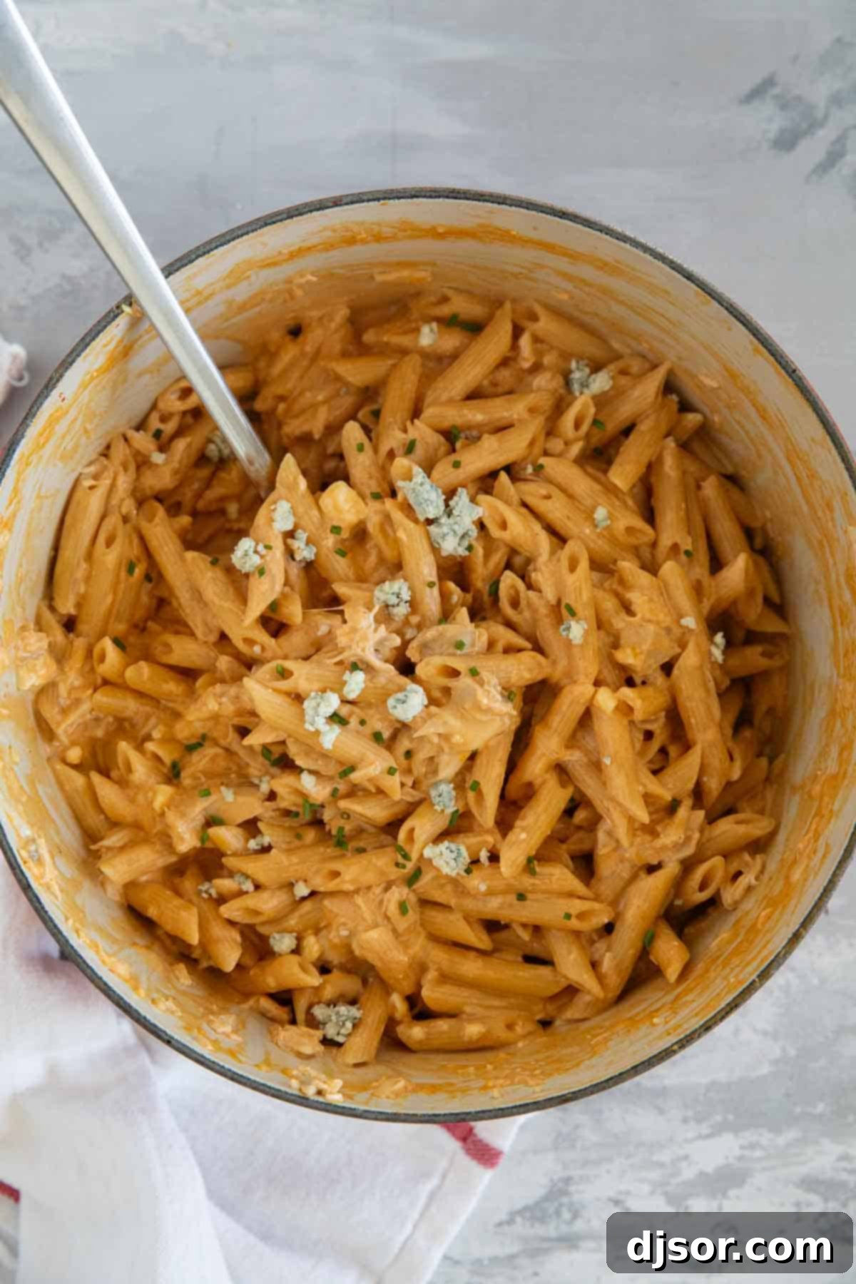 Ultimate Buffalo Chicken Pasta 8 Pot filled with buffalo chicken pasta topped with blue cheese and chives.