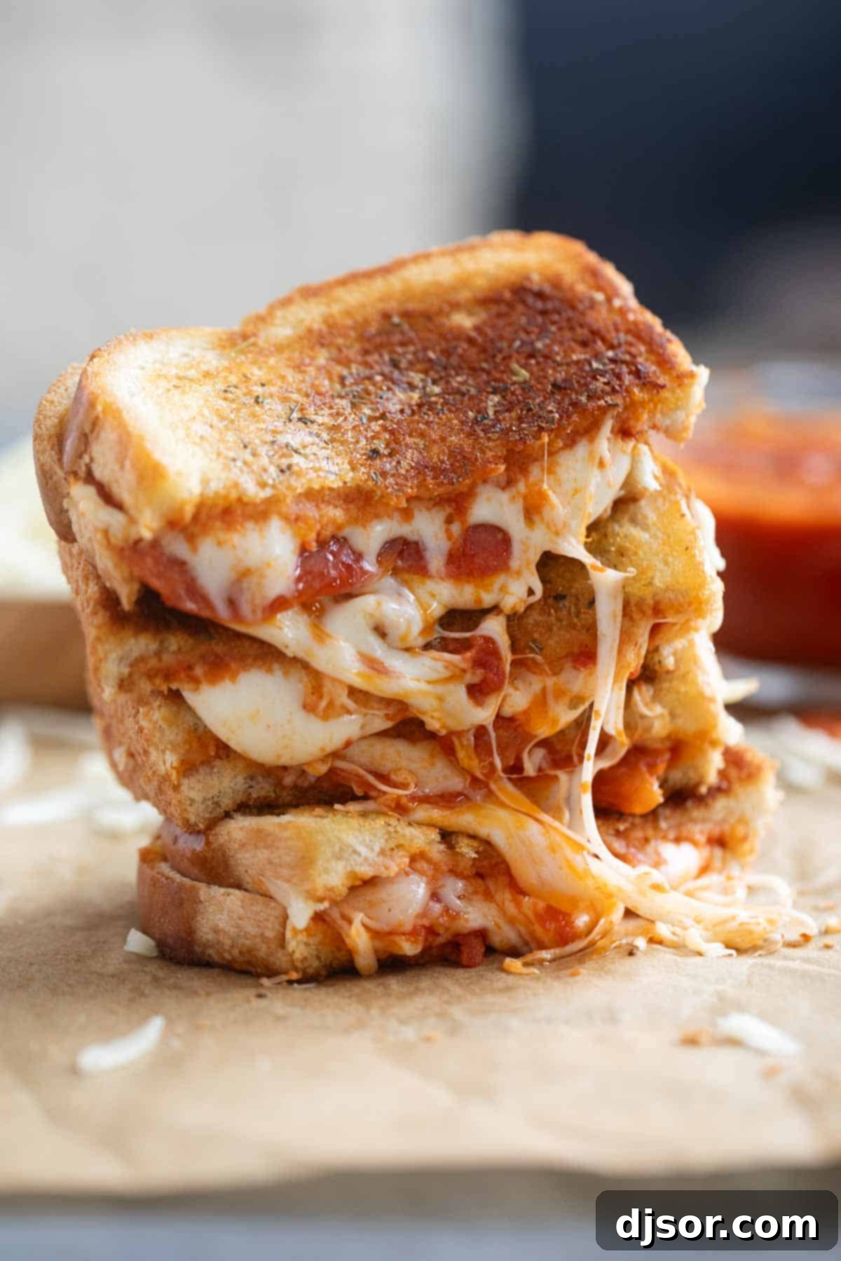 Multiple pizza grilled cheese sandwiches stacked on top of each other, ready to be served.