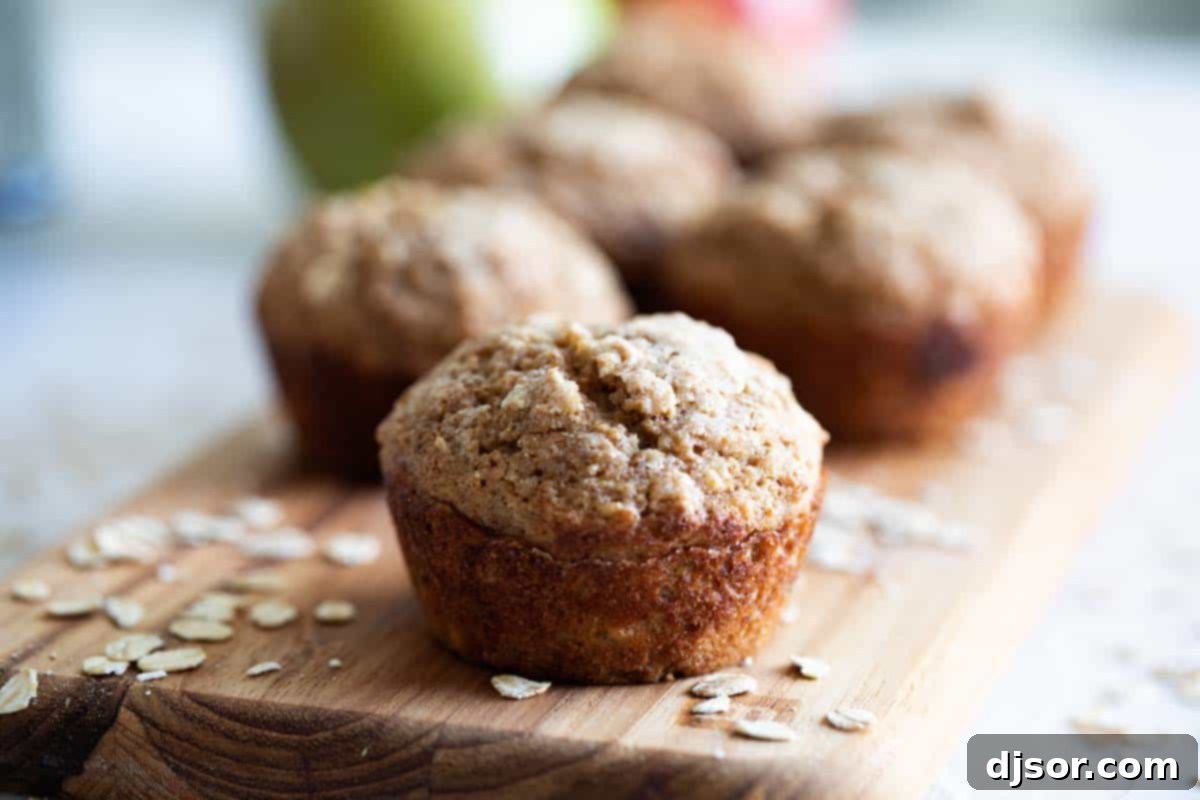 Healthy Applesauce Oatmeal Muffins - A Wholesome Breakfast Treat Delicious and healthy oatmeal muffins with applesauce on a wooden cutting board, perfect for breakfast.