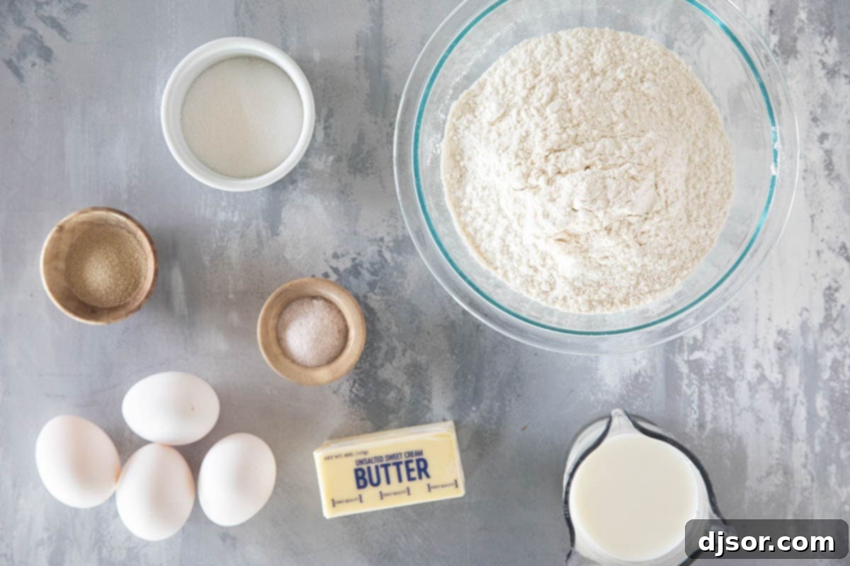 Essential ingredients for Brioche Rolls laid out on a baking surface.