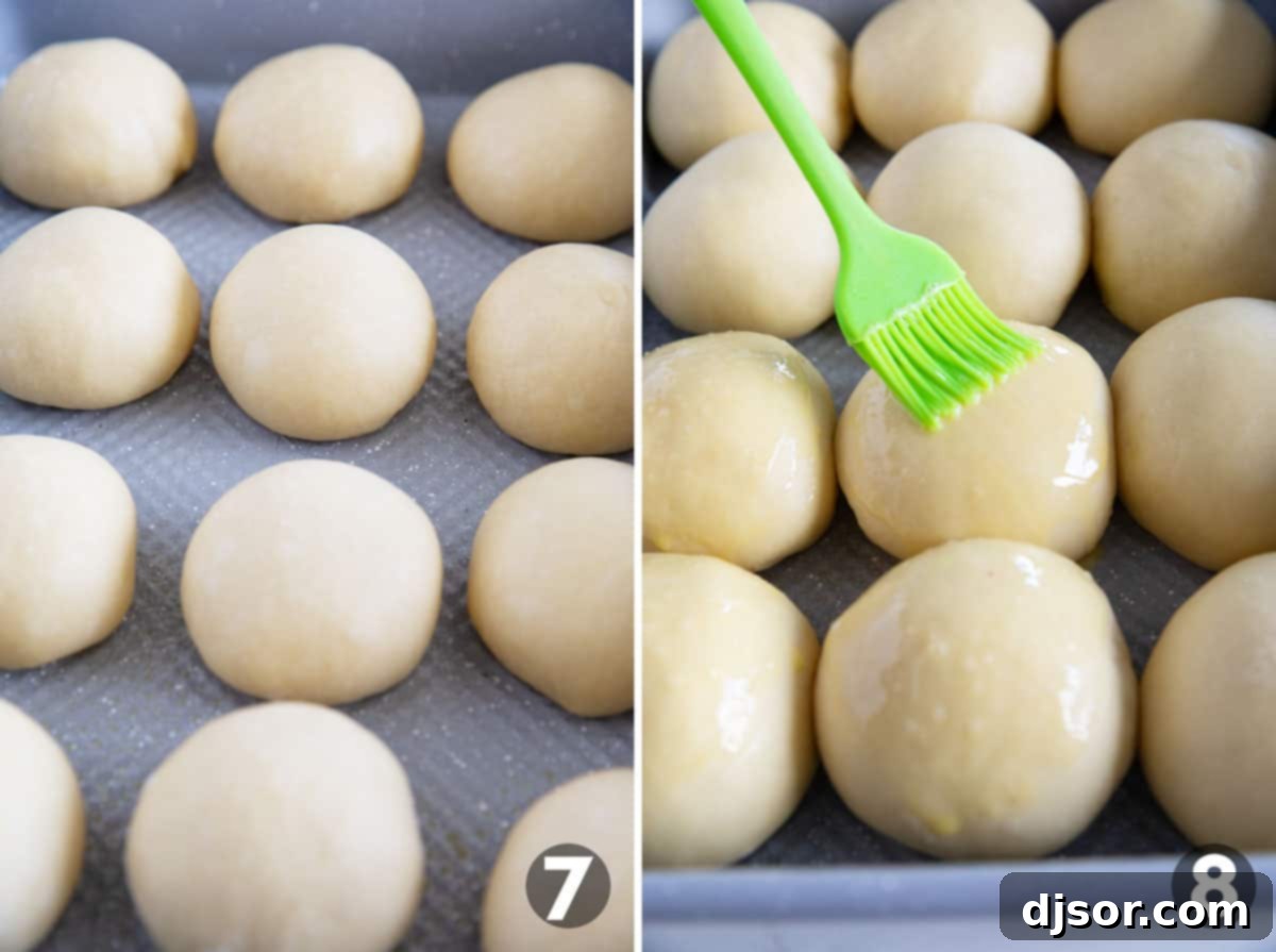 Shaped brioche rolls placed in a baking pan for their second rise, then brushed with egg wash.
