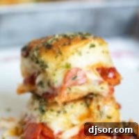 Pepperoni Pizza Poppers 10 Two pepperoni pizza sliders stacked on top of each other.