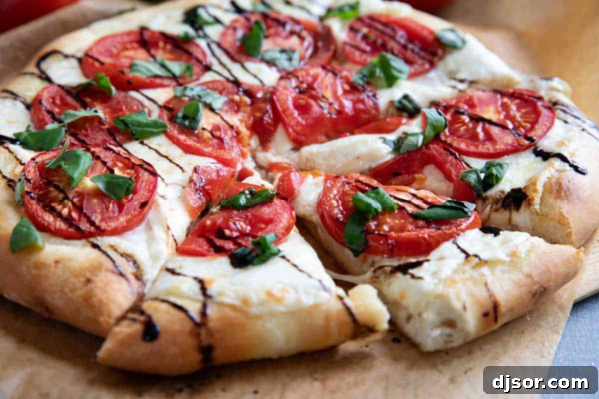 Full Caprese Pizza cut into slices.