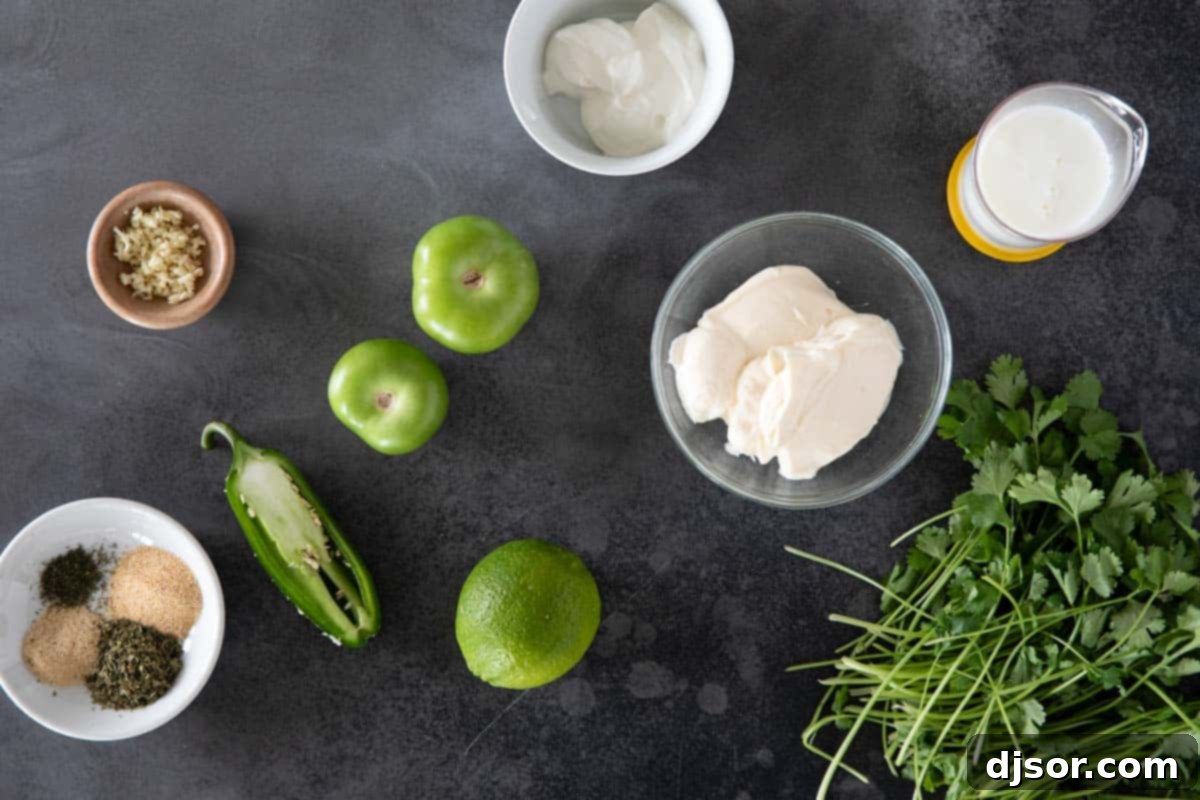 Assortment of fresh ingredients for Tomatillo Ranch Dressing including vibrant green tomatillos, fresh cilantro, bright limes, and fragrant garlic cloves.
