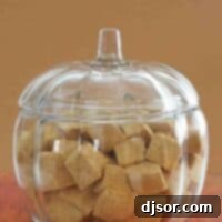 Spiced Pumpkin Fluffs 2 A charming glass pumpkin-shaped bowl overflowing with fluffy, square-cut Pumpkin Spice Marshmallows.