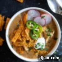 overhead view of a bowl filled with chicken enchilada soup