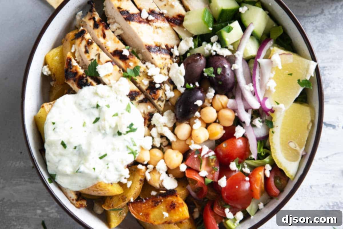 Greek Chicken Bowls topped with homemade tzatziki sauce.