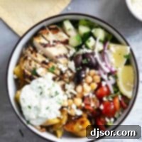 Greek Chicken Bowls with greek roasted potatoes, grilled chicken, and homemade tzatziki sauce.