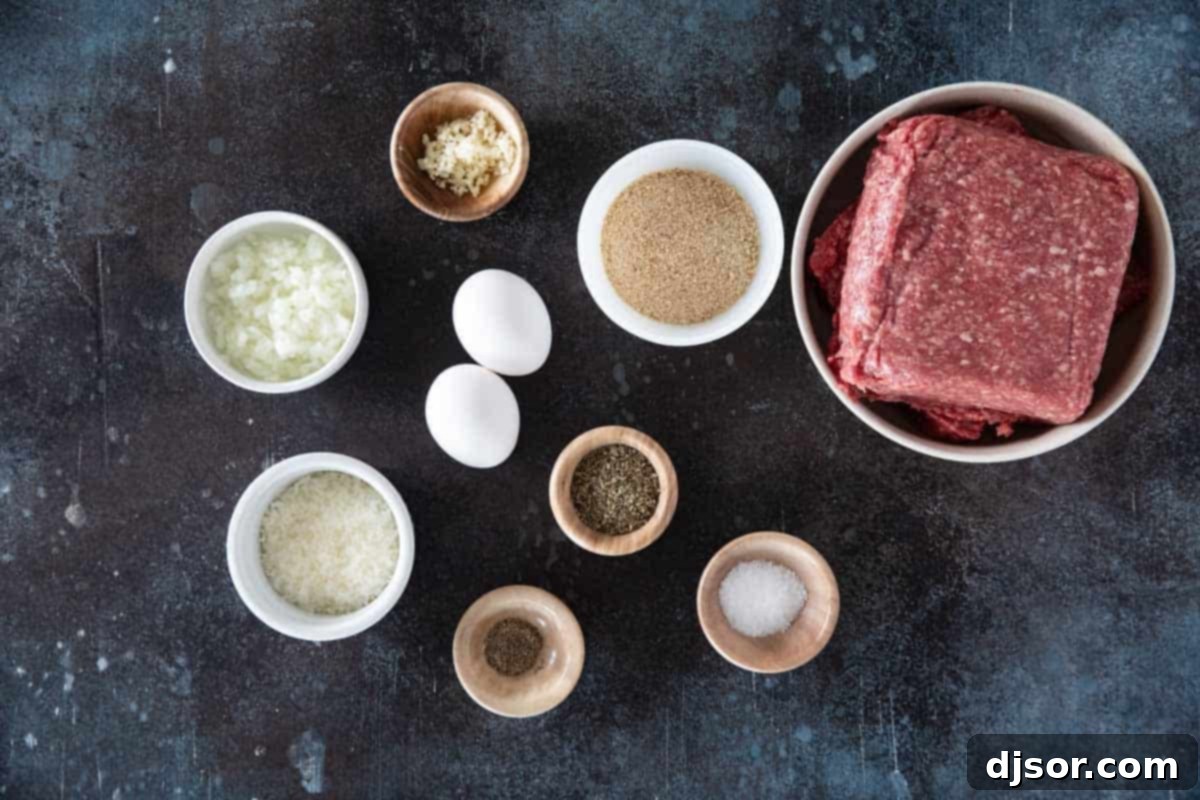 Savory Baked Meatballs 3 A vibrant display of fresh ingredients for baked meatballs, including lean ground beef, eggs, breadcrumbs, Parmesan cheese, finely chopped onion, minced garlic, and Italian seasonings, neatly arranged on a wooden board.