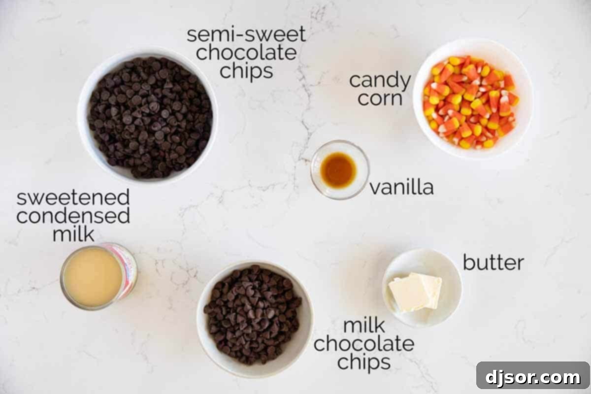 A visual display of all the essential ingredients laid out for making delicious Candy Corn Fudge, including chocolate chips, sweetened condensed milk, butter, vanilla extract, and colorful candy corn.