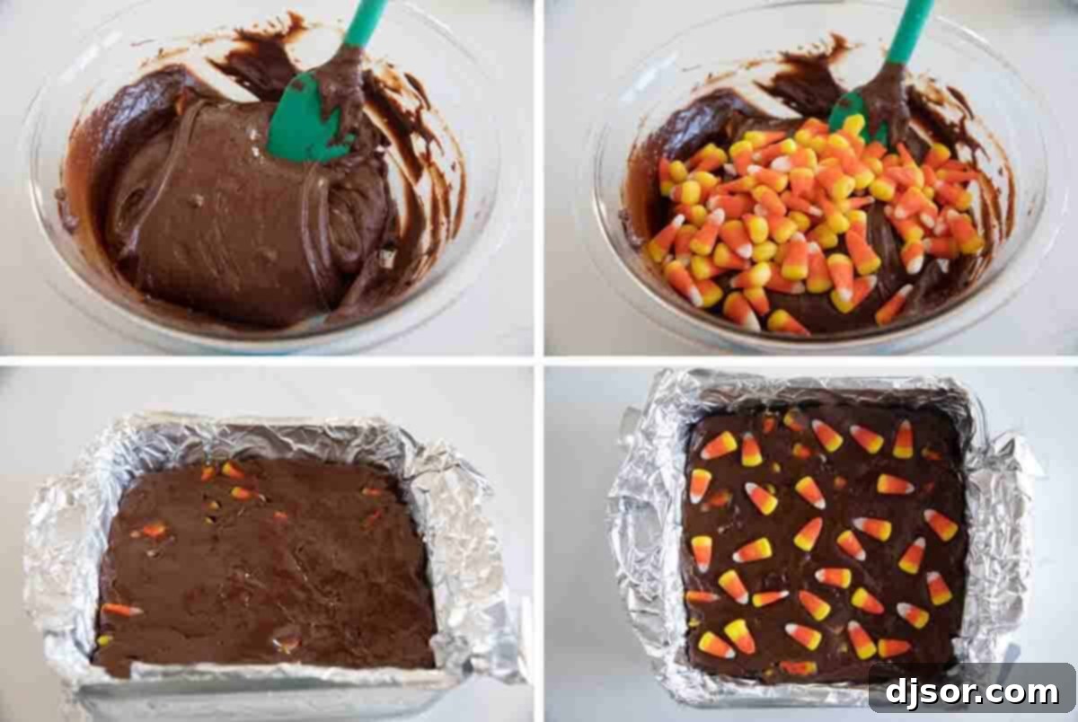 Smooth, melted fudge mixture being poured into a foil-lined baking dish, ready to be spread and set, with colorful candy corn waiting to be added.