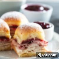 Sweet and Savory Monte Cristo Minis 8 Monte Cristo Sliders on a plate with raspberry jam for serving.